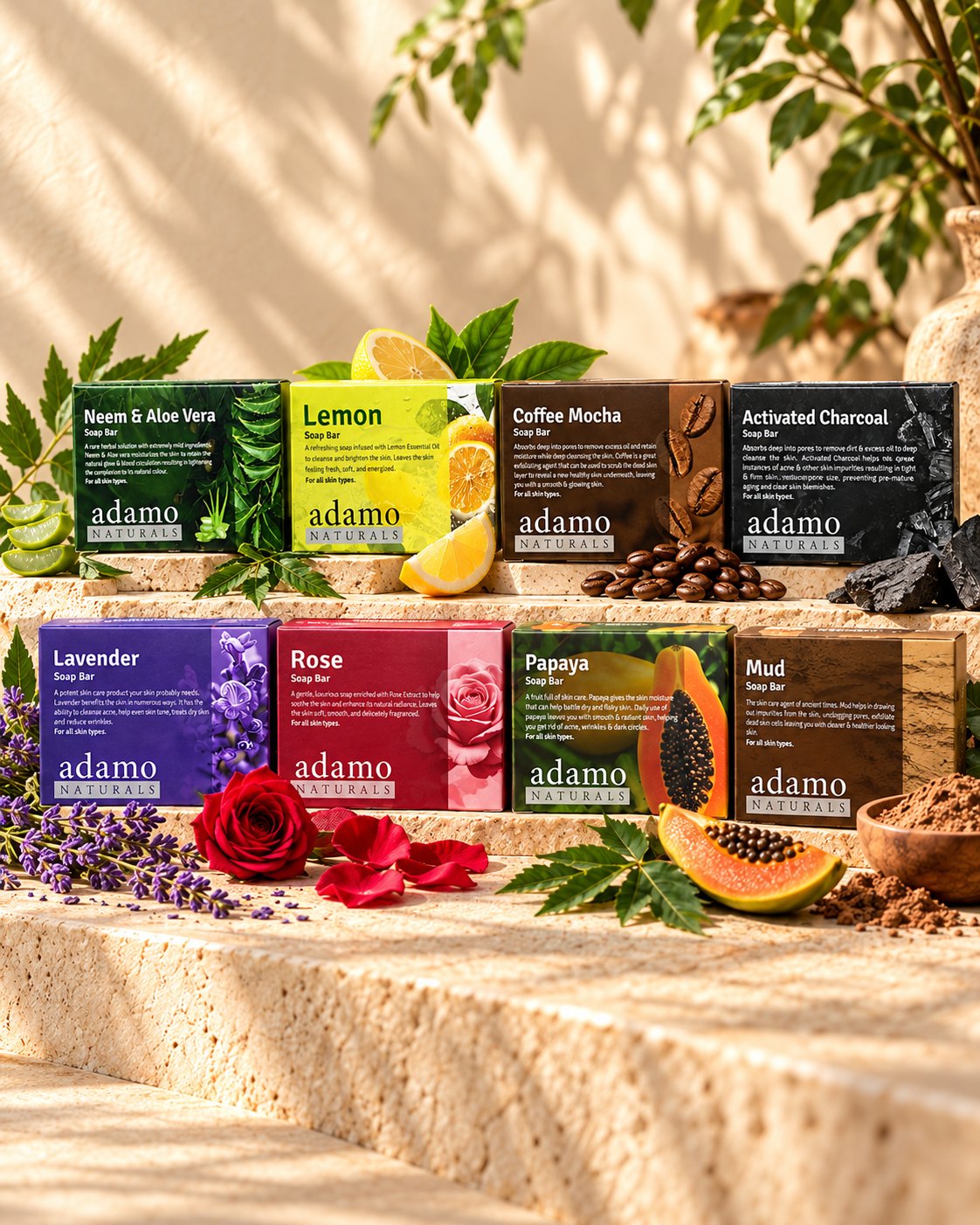 Eight handmade Adamo Naturals soap bars on a stone ledge with their ingredients